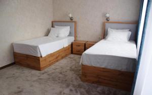 two beds in a room with two beds sidx sidx sidx at MirOtel Hotel in Astana