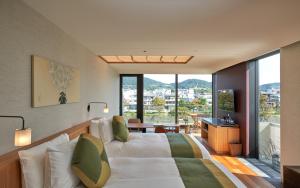 A bed or beds in a room at Genji Kyoto, a Member of Design Hotels