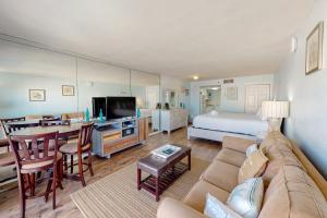 a living room with a couch and a dining room at Islander W 605 in Fort Walton Beach