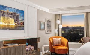 a hotel room with a bed and a desk and a chair at Bellagio in Las Vegas