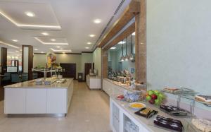 a restaurant with a buffet line with food on display at Hilton Garden Inn Astana in Astana