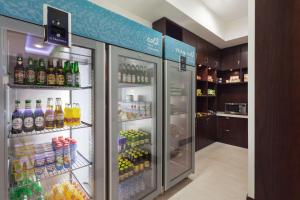 a refrigerator filled with lots of different types of drinks at Hilton Garden Inn Astana in Astana