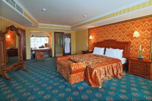 a hotel room with a large bed and a mirror at Diplomat Hotel by AG Hotels Group in Astana