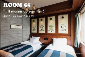 Letto o letti in una camera di ピーナッツホテル/PEANUTS HOTEL