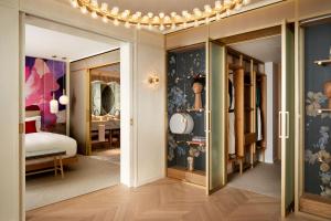 a room with a bedroom with a bed and a mirror at The BoTree - Preferred Hotels and Resorts in London