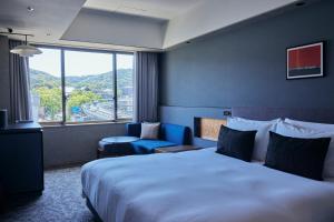 A bed or beds in a room at NOHGA HOTEL KIYOMIZU KYOTO