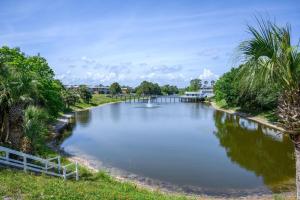 a river with a bridge in the middle at Emerald Escape Peekaboo Beach View 3 Pools in Destin