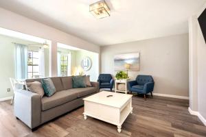 a living room with a couch and two chairs at Emerald Escape Peekaboo Beach View 3 Pools in Destin