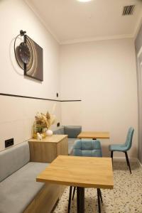 a room with two tables and a clock on the wall at Five Hotel in Astana