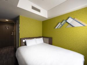 Posteľ alebo postele v izbe v ubytovaní ibis Styles Kyoto Shijo