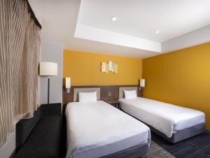 Posteľ alebo postele v izbe v ubytovaní ibis Styles Kyoto Shijo