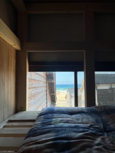 Voodi või voodid majutusasutuse ゲストハウス黒島 toas
