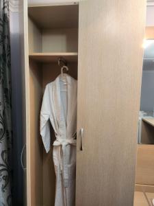 a white suit is hanging in a closet at Baiterek Premium in Astana