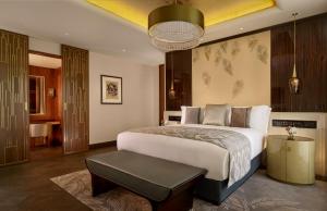 a bedroom with a large bed and a table at The Ritz-Carlton, Astana in Astana