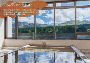 a pool of water with a view of a mountain at Kamenoi Hotel Aso Park Resort in Aso