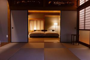 a bedroom with a bed inside of a room at Hakusyu - Vacation STAY 11460v in Aso