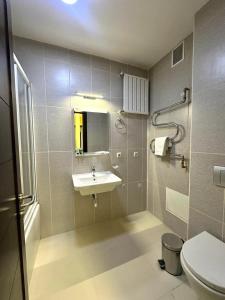 a bathroom with a sink and a toilet at ASYR Hotel in Astana