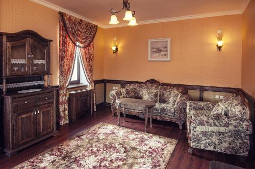 a living room with a couch and a table at Boutique Hotel Traditional in Astana