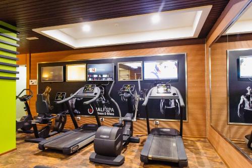 a gym with treadmills and cardio equipment in a room at Diplomat Hotel by AG Hotels Group in Astana