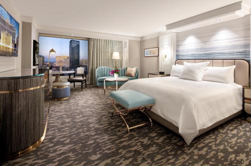 a bedroom with a large bed and a living room at Bellagio in Las Vegas