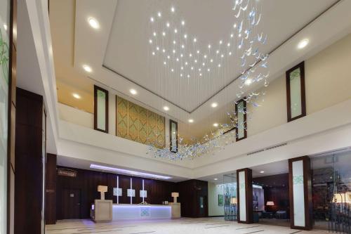 a large lobby with a chandelier in the ceiling at Hilton Garden Inn Astana in Astana