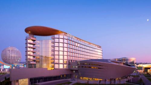 a large building with a bean on top of it at Hilton Astana in Astana