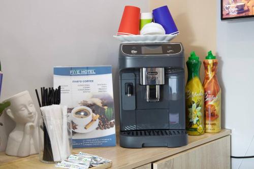 a coffee maker sitting on top of a counter at Five Hotel in Astana