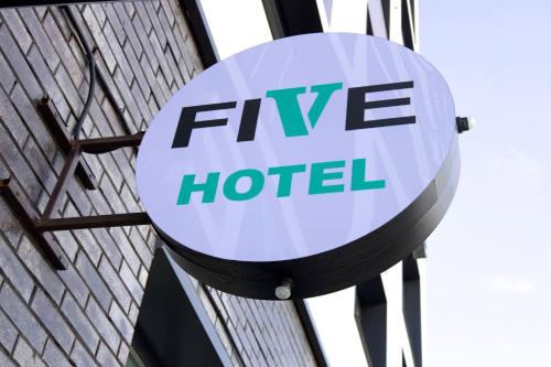 a sign for a five hotel on the side of a building at Five Hotel in Astana