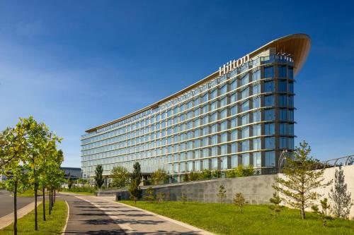 a building with a sign on the side of it at Hilton Astana in Astana