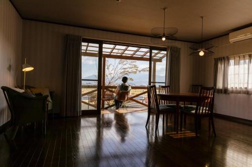 a person standing in a living room with a table at Hakusyu - Vacation STAY 11460v in Aso