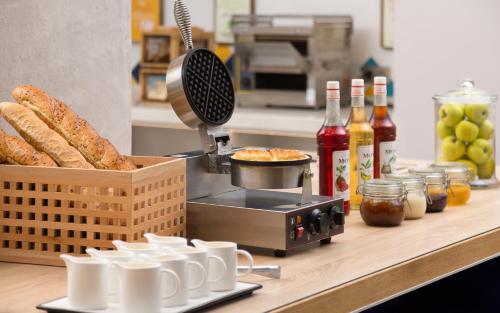 a counter with bread and bottles of wine and bottles of sauce at Hampton By Hilton Astana Triumphal Arch in Astana