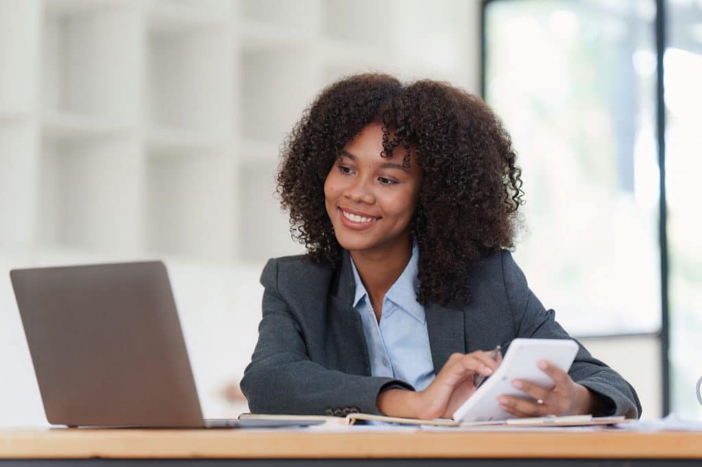 Financial advisor, corporate accountant and african woman in office. analyzing benefits, enjoying