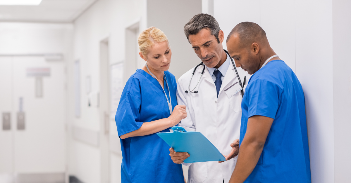 Doctors looking at a clipboard observing how they can make their billing systems better