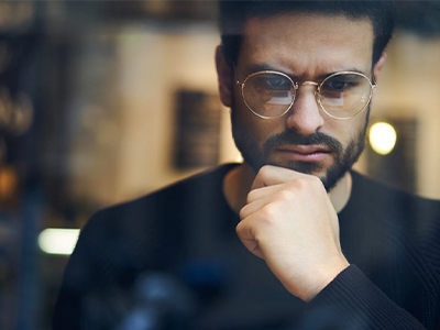 A man holding his chin