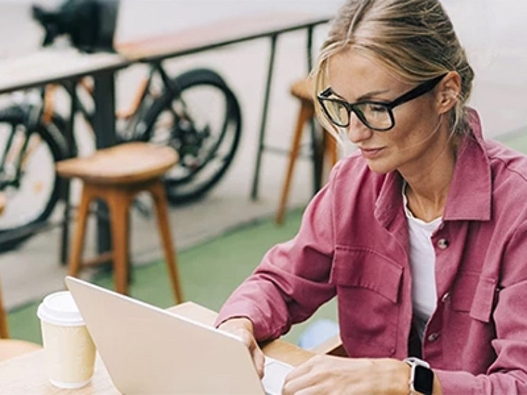 A woman sitting on an working on her laptop