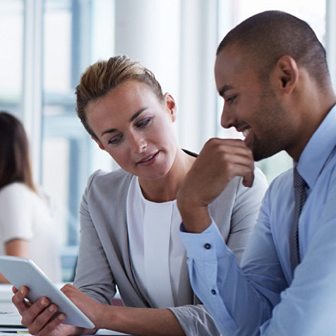 two people looking at a tablet