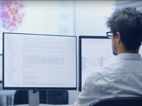 an office worker looking at his desktop screen