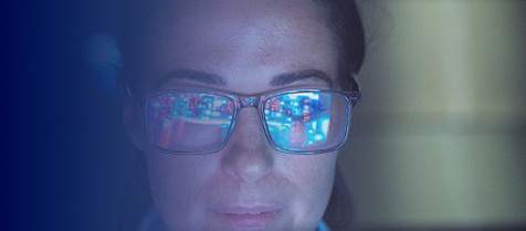 Woman wearing glasses looking at computer screen