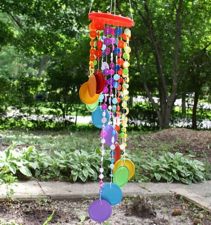This button wind chime in rainbow colors is one of my favorite projects in my new book. It's an awesome kid's craft or adult craft for summer! #rainbowcrafts #windchimes #buttoncrafts #buttons #gardencrafts #gardendecor #recycledcrafts #kidscrafts #adultcrafts Rainbow Button Wind Chime by Amanda Formaro of Crafts by Amanda, an excerpt from her latest book, Button Mania