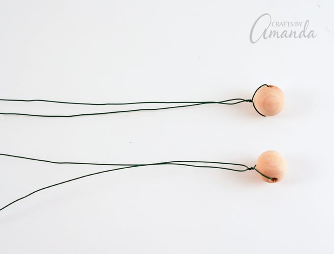 Twist the wire a few times to secure the bead. Repeat for the second wire.