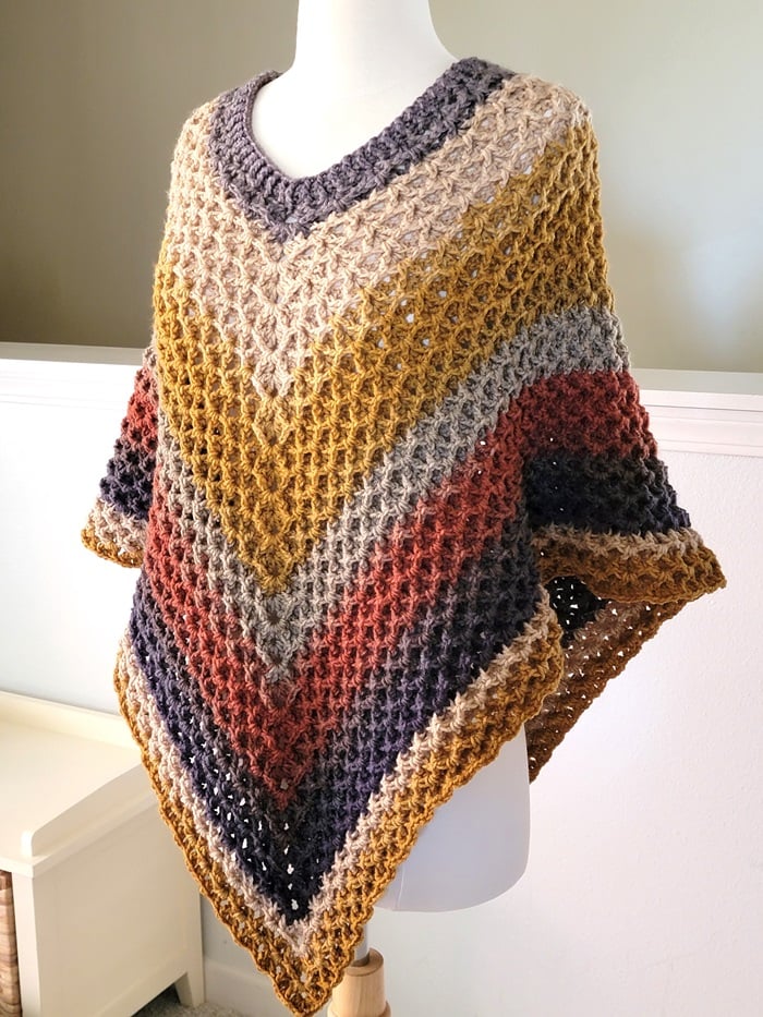 Crochet hooded poncho pattern finished and displayed on a mannequin
