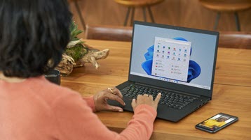 Woman working on laptop running Windows 11