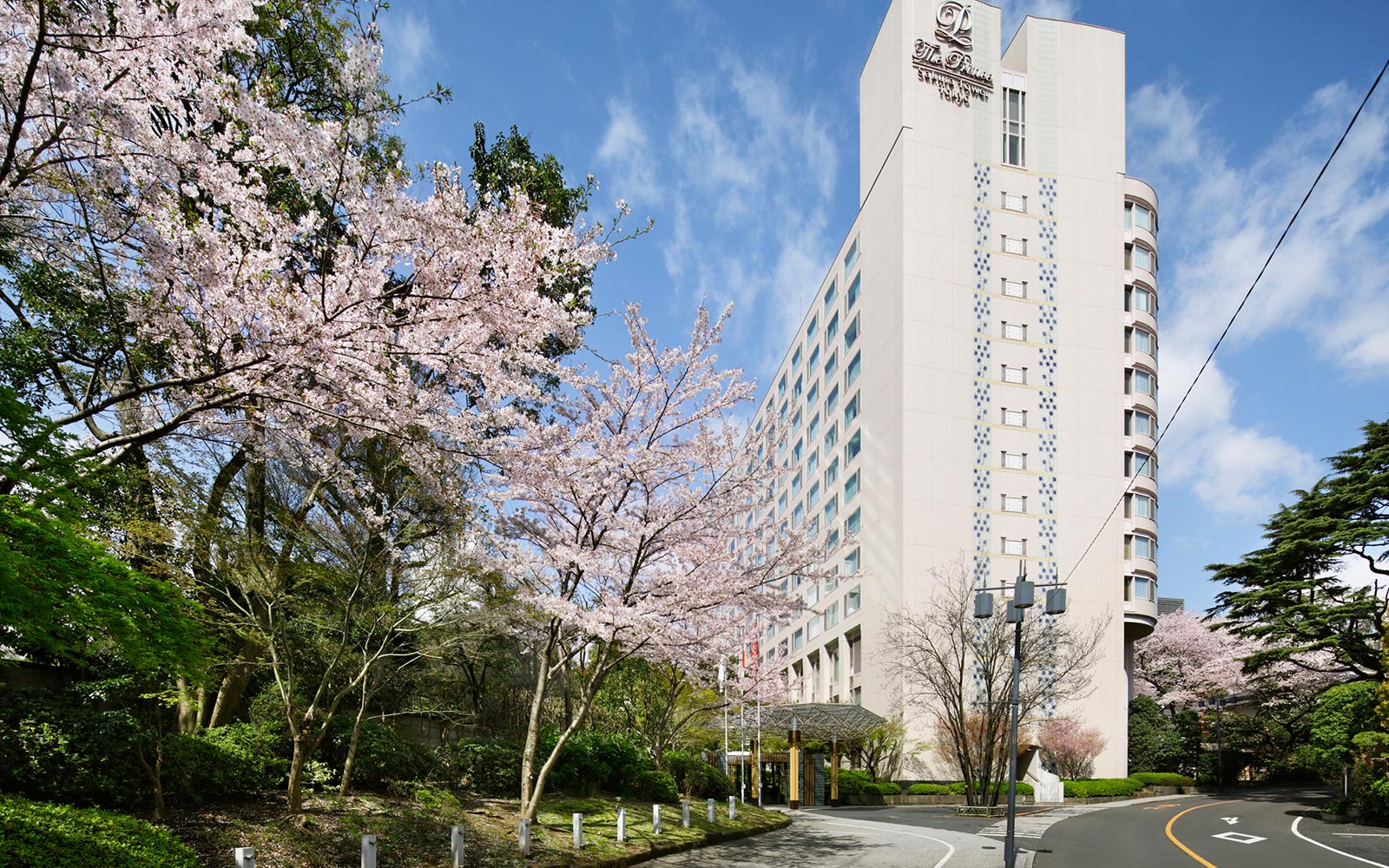 A Tall Building With Trees In Front Of It