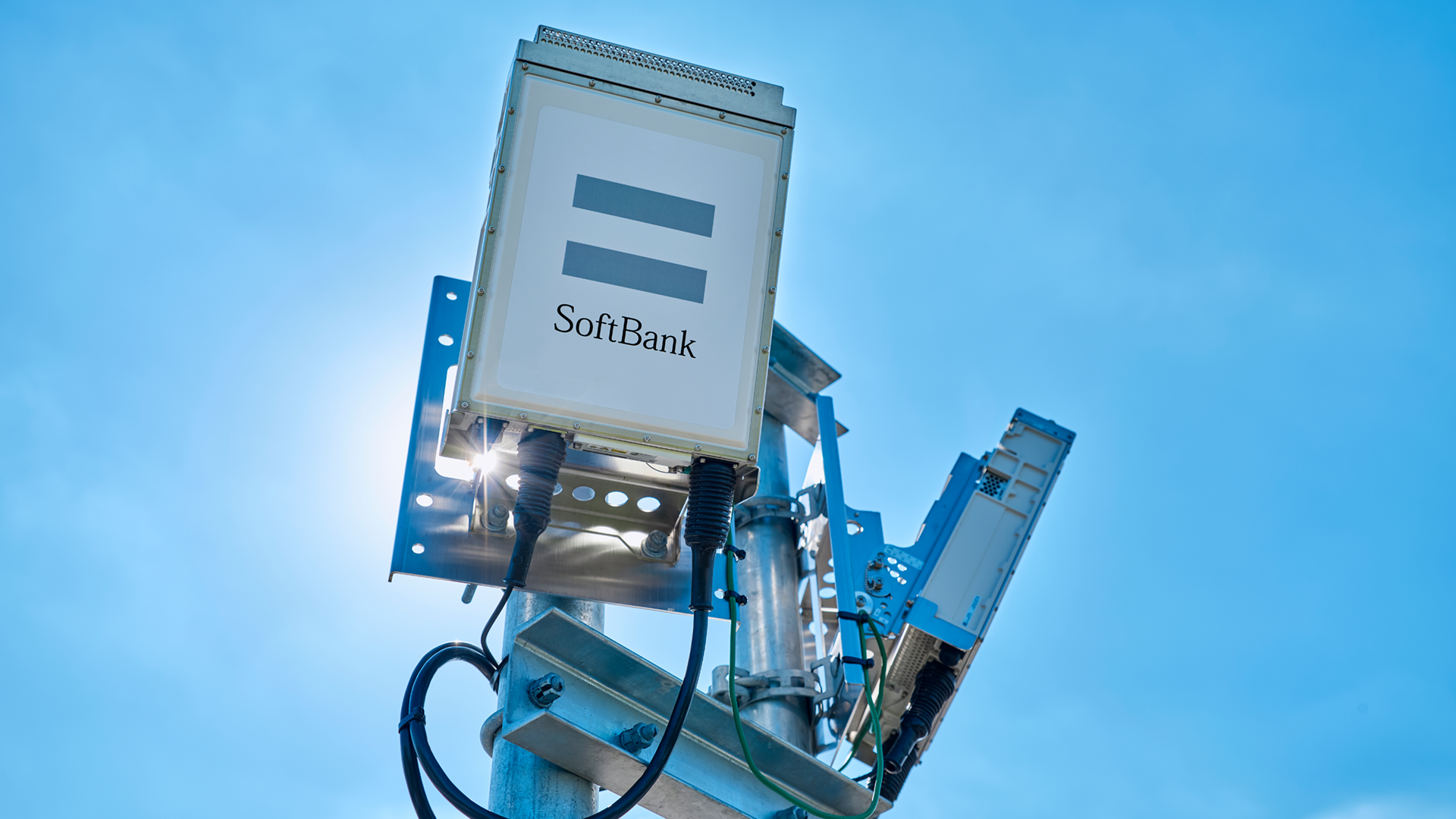 A photo of a SoftBank mobile UE against a cloudless blue sky.