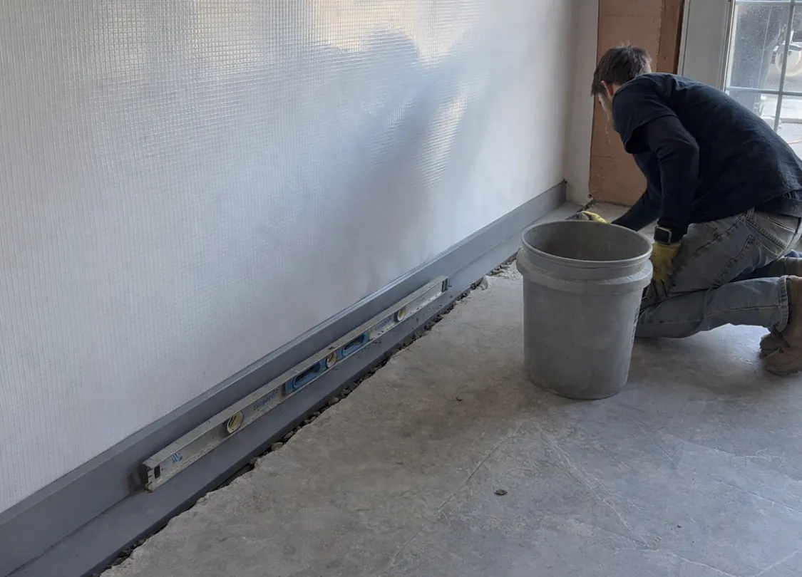 basement perimeter drainage being installed