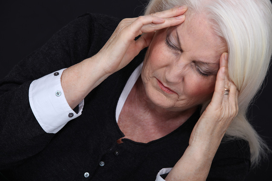 A woman holding her head in her hands