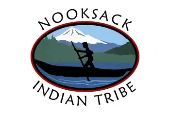 nooksack-tribe-logo-2 Nooksack Indian Tribe logo featuring a silhouette of a person paddling a canoe against a backdrop of mountains and water, symbolizing heritage and connection to nature.