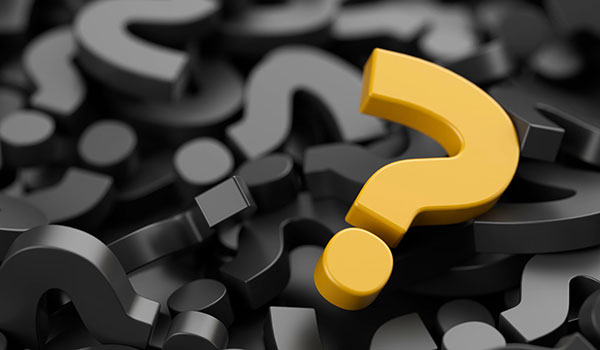 A pile of black 3D question marks with a yellow 3D question mark sitting on top.
