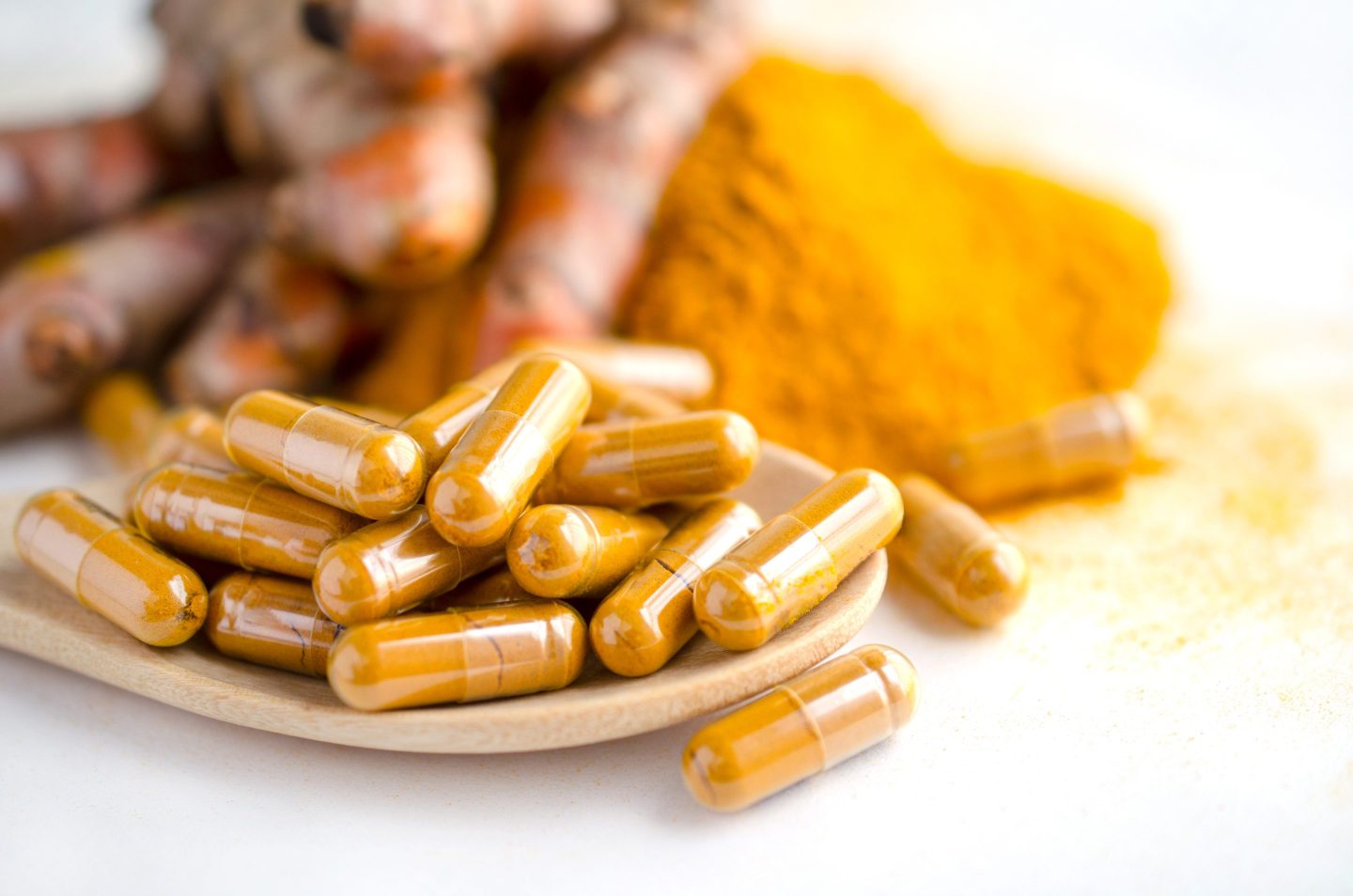 Photo of turmeric powder and capsules