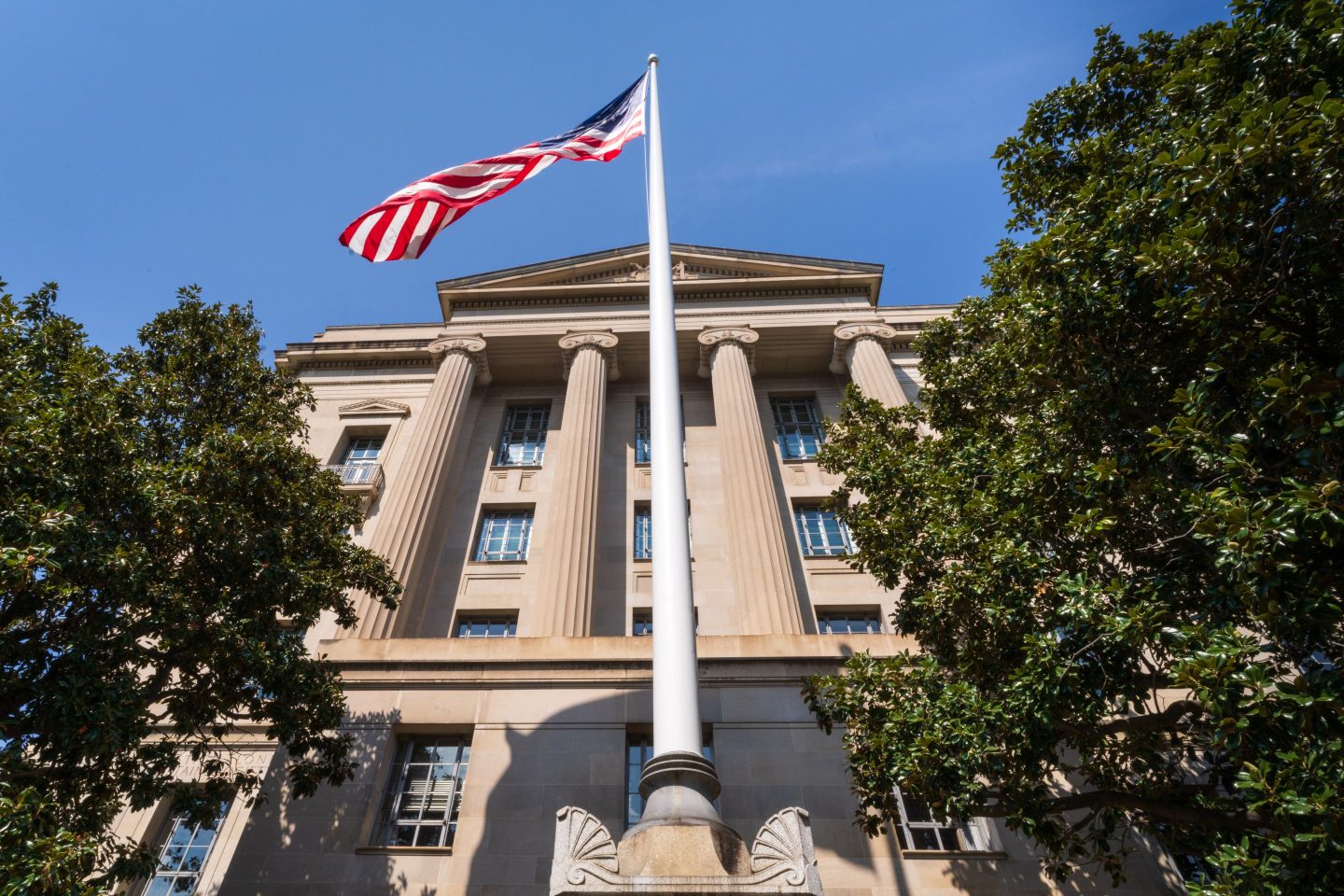 WASHINGTON, DC &#8211; SEPTEMBER 15: A U.S. flag flies in front of the U.S. Department of Justice (DOJ) headquarters building on September 15, 2024, in Washington, DC. (Photo by J. David Ake/Getty Images)